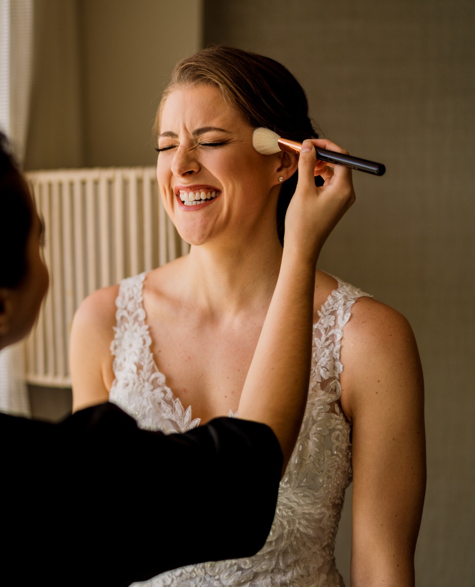 Smiling Bride Getting Makeup Applied by Kristy's Artistry Artist