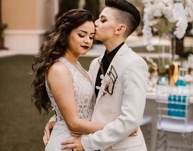 LGBTQ Couple Embracing - Two Brides with Hair and Makeup by Kristy's Artistry Design Team
