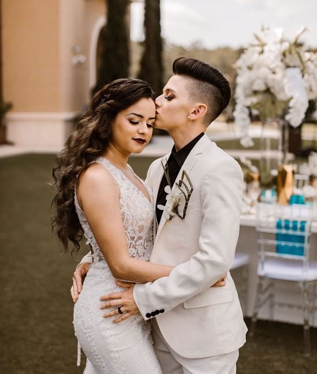 LGBTQ Couple Embracing - Two Brides with Hair and Makeup by Kristy's Artistry Design Team