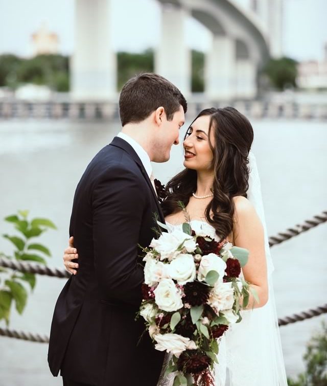 Romantic Wedding Kiss - Groom Kisses Bride with Stunning Hair and Makeup by Kristy's Artistry Design Team in Orlando, FL