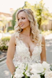 Captivating bride looking to the right after receiving exquisite hair and makeup by Kristy's Artistry Design Team