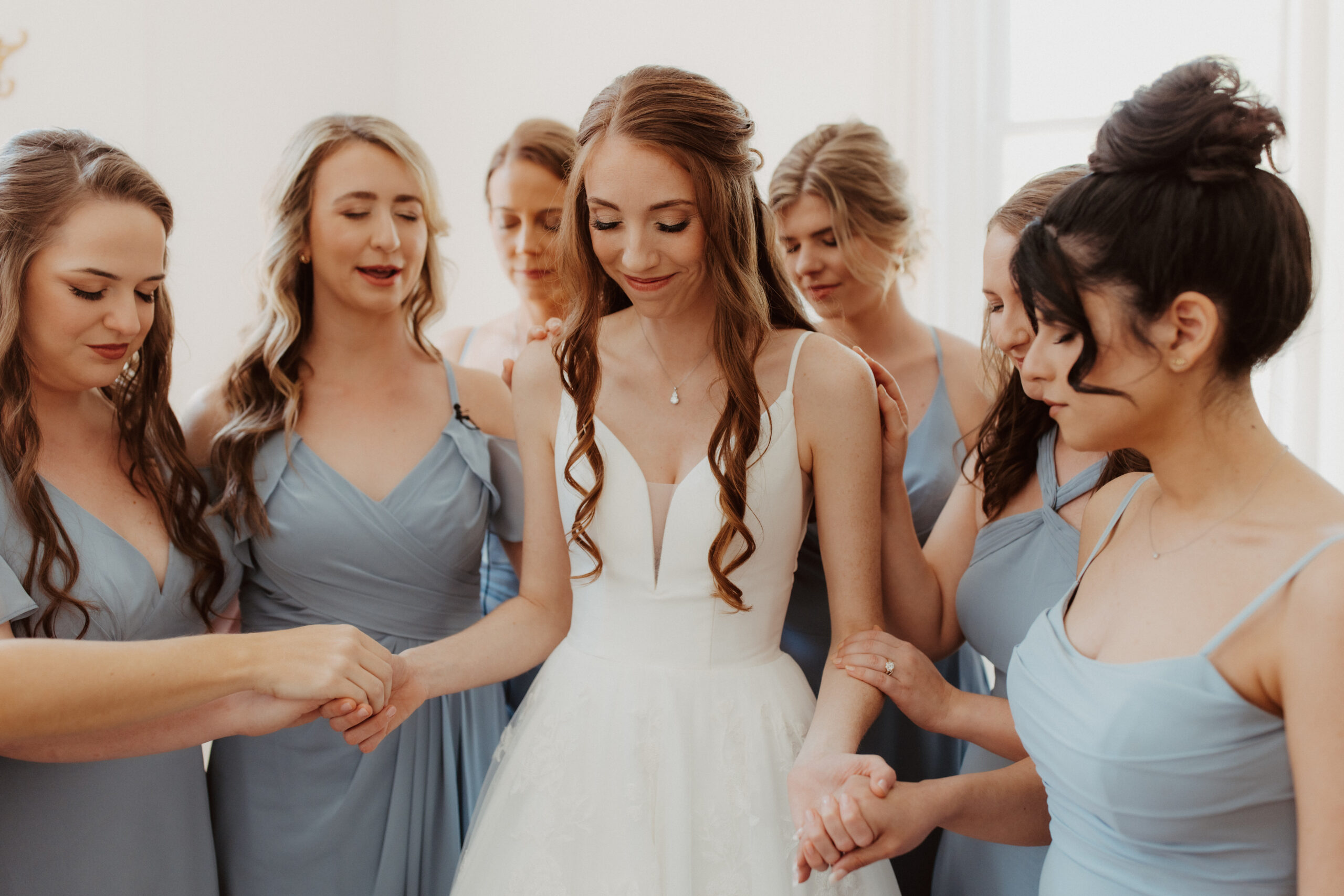 Bride and bridesmaids showcasing their flawless wedding hair and makeup by Kristy's Artistry Design Team in Orlando