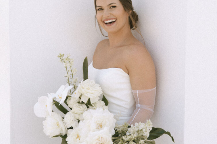 Smiling Bride Holding Flowers with Classic Hair and Makeup by Kristy's Artistry Design Team