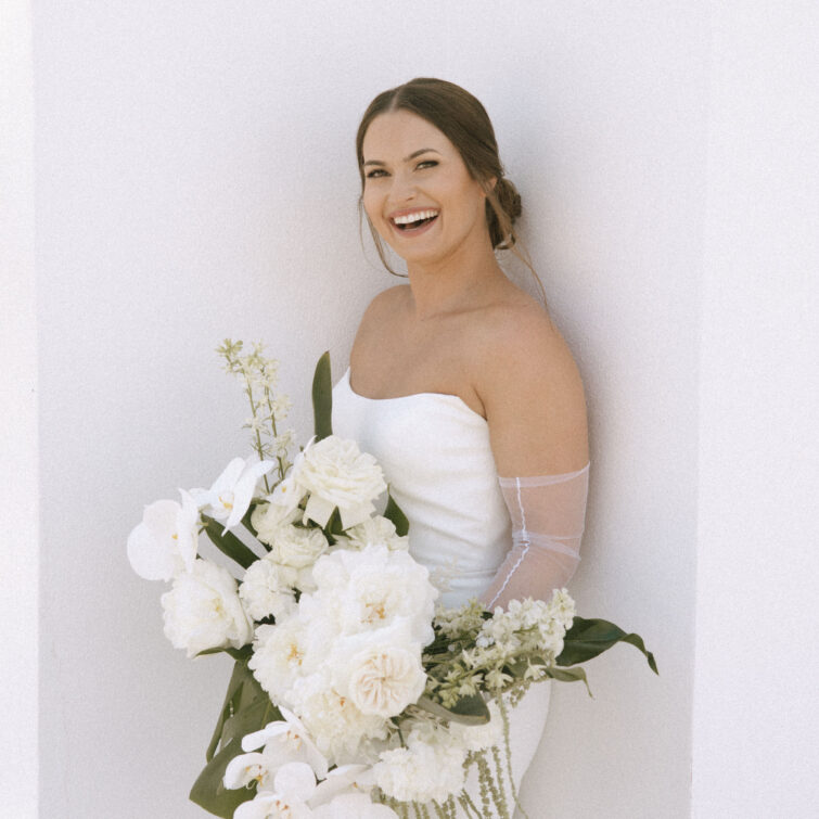 Smiling Bride Holding Flowers with Classic Hair and Makeup by Kristy's Artistry Design Team