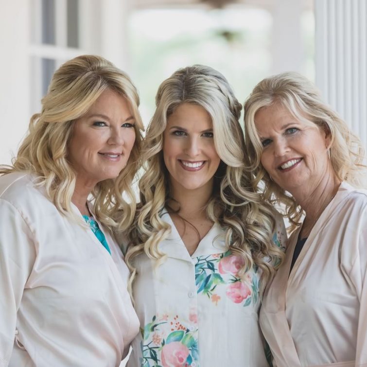Bride, mother, and mother-in-law showcasing their classic wedding hairstyles by Kristy's Artistry Design Team in Orlando