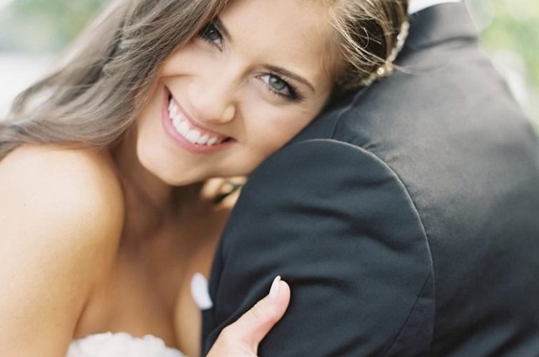Intimate Moment: Bride Resting on Groom's Shoulder with Hair and Makeup by Kristy's Artistry Design Team