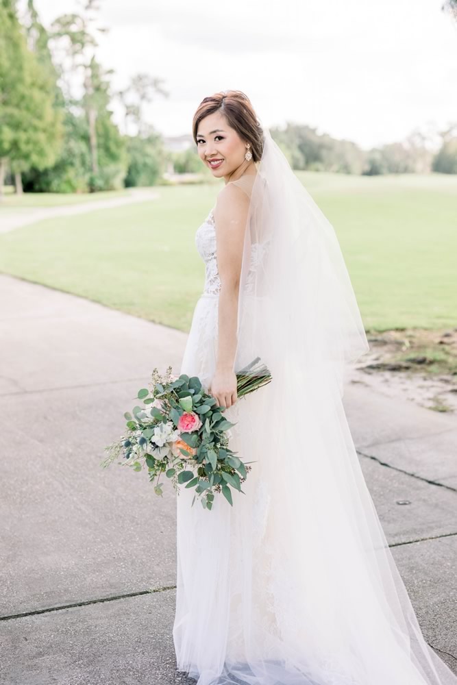 Smiling Asian Bride with Classic Hairstyle by Kristy's Artistry Design Team