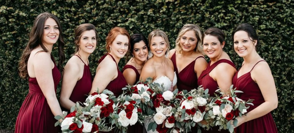 Bride and 7 bridesmaids looking fantastic and smiling after hair and makeup at Kristy's Artistry Design Team
