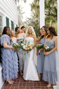 Bride and bridesmaids in a stunning hair and makeup reveal by Kristy's Artistry Design Team