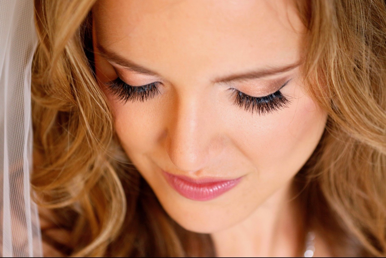 Close-up of a bride showcasing her stunning makeup done by Kristy's Artistry Design Team.