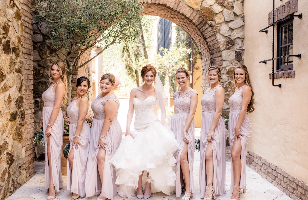 Bride and bridesmaid proudly displaying their finished looks pre-wedding, with hair and makeup done by Kristy's Artistry Design Team.