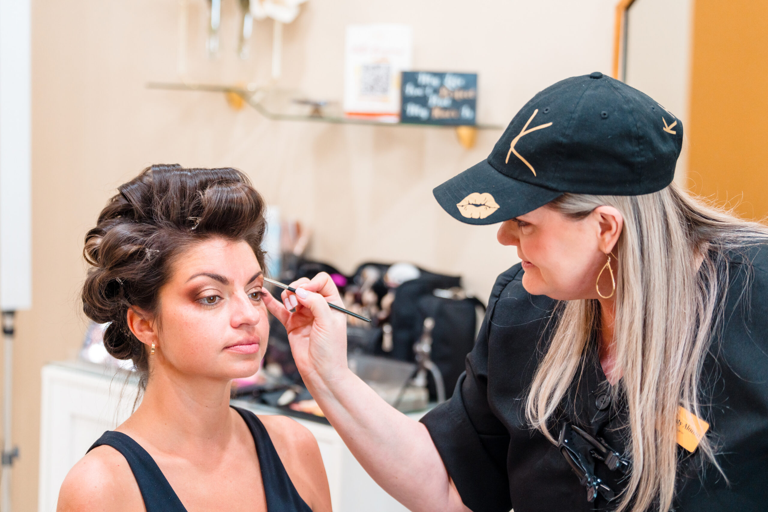 Kristy from Kristy's Artistry Design Team performing a professional makeup application on a bride in Orlando, FL.