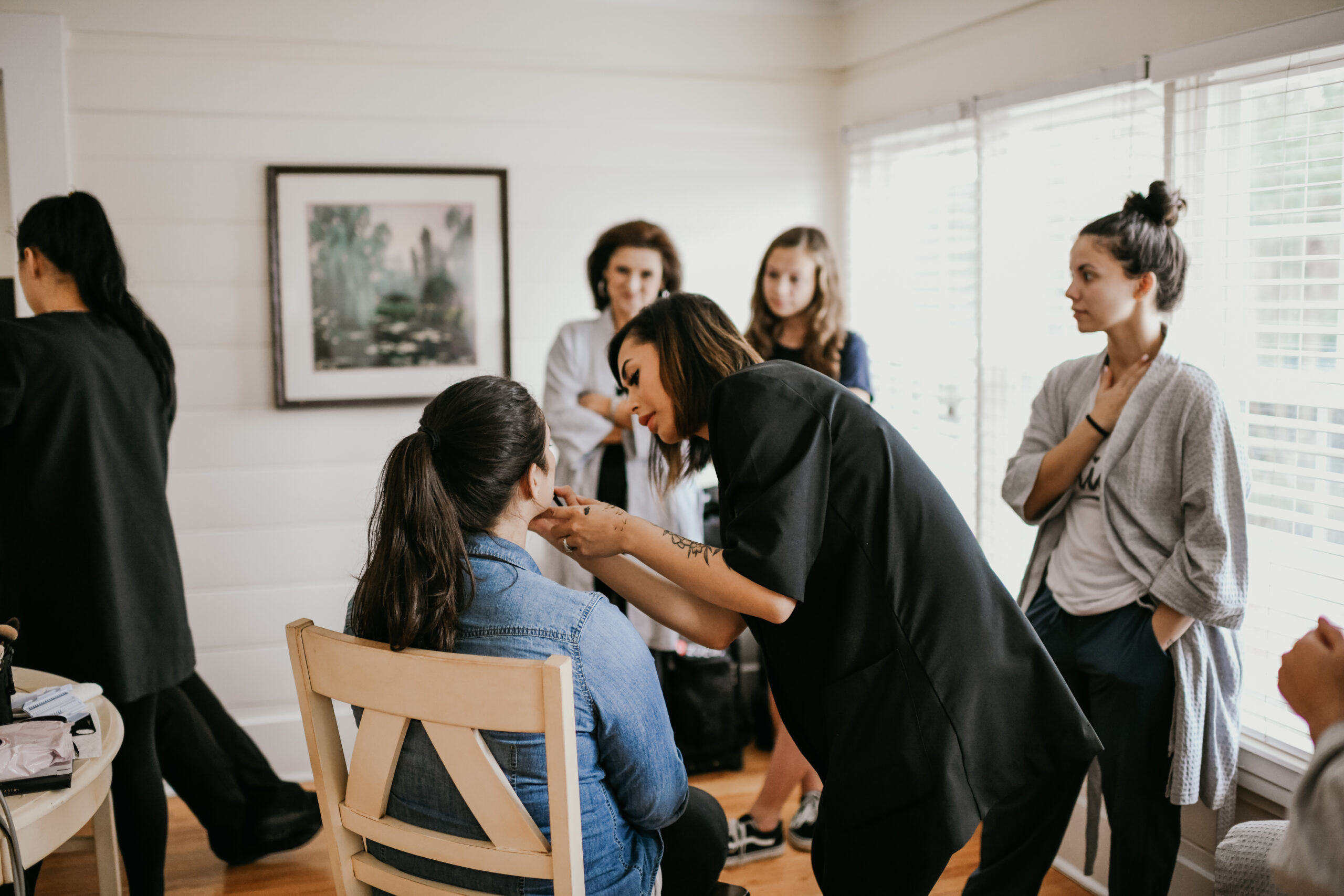 The best mobile makeup artists in Orlando, Kristy's Artistry Design Team working on hair and makeup for the bridal party pre-wedding.