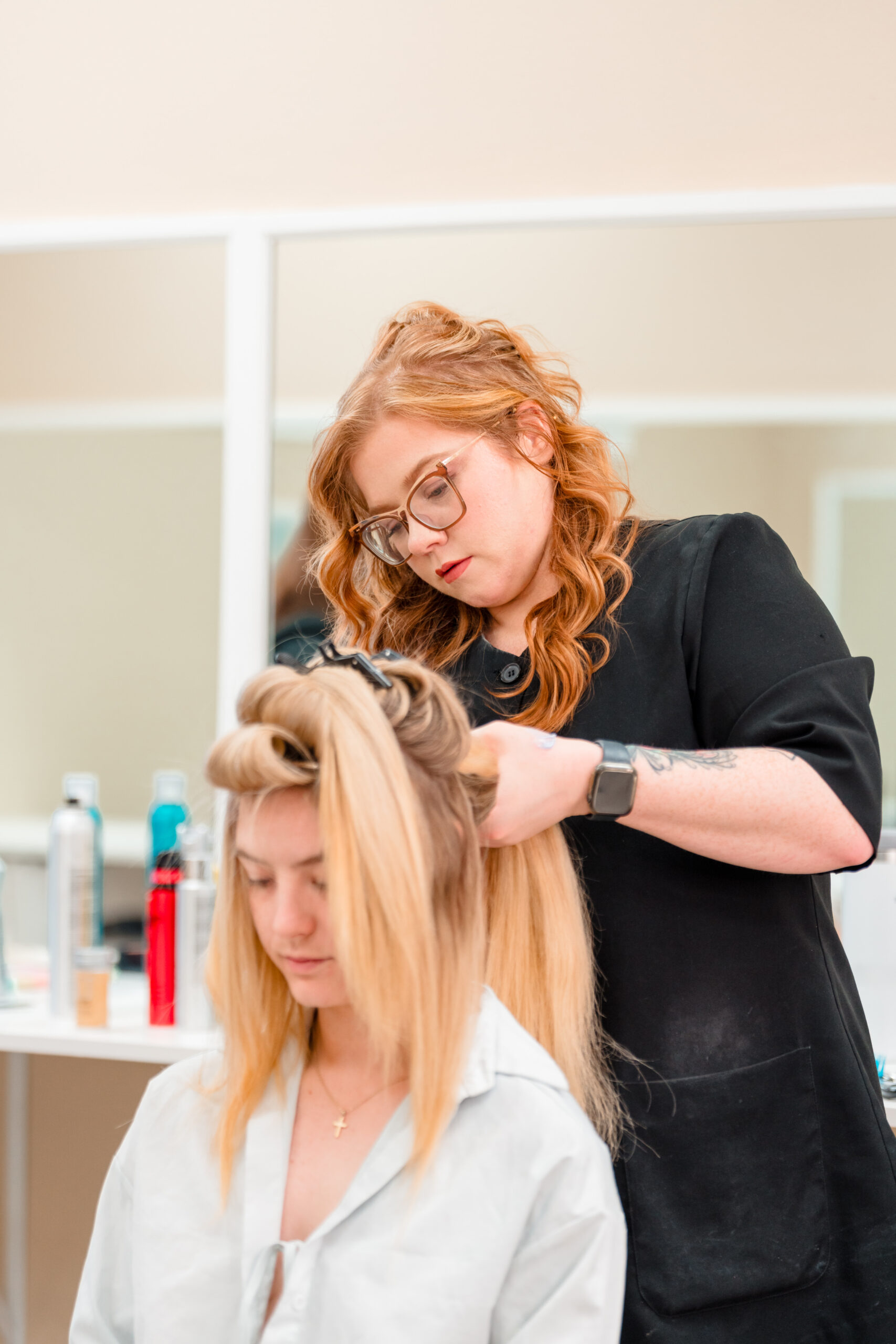 Master hairstylist from Kristy's Artistry Design Team working on bridal hair in the bridal suite in Orlando, FL.