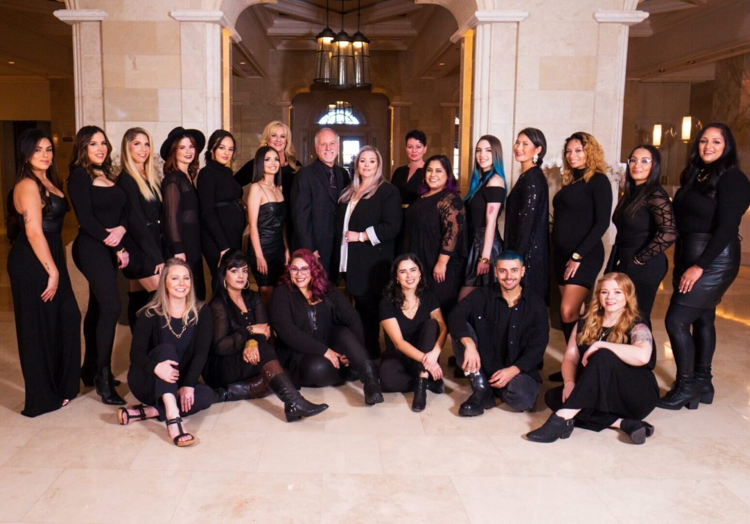 Group of people posing in elegant attire.